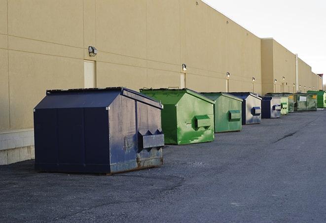 a group of construction workers taking a break near a dumpster in Broken Arrow